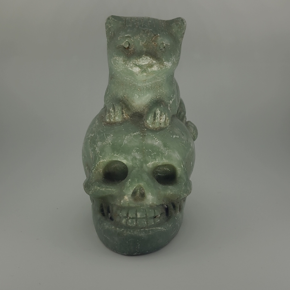 Green Cat Figurine on Skull